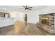 Open-concept living room featuring wood floors, fireplace, ceiling fan and natural light at 1404 Santa Margarita St # D, Las Vegas, NV 89146