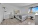 Cozy bedroom with tile flooring, a comfortable bed, and a window offering natural light at 1440 Vegas Valley Dr # 1, Las Vegas, NV 89169