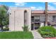 View of the stucco condo with a red tile roof, balcony, arched windows, and verdant landscaping at 1440 Vegas Valley Dr # 1, Las Vegas, NV 89169