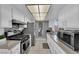 The bright kitchen features stainless steel appliances, granite countertops, tile floors, and modern cabinetry at 1440 Vegas Valley Dr # 1, Las Vegas, NV 89169