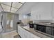 Well-lit kitchen with stainless steel appliances, granite counters, white cabinets, and tile flooring at 1440 Vegas Valley Dr # 1, Las Vegas, NV 89169