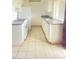 Bright kitchen features tile floors, white cabinets, and granite countertops with a double stainless steel sink at 1440 Vegas Valley Dr # 14, Las Vegas, NV 89169