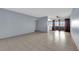 A spacious living room with tile flooring, leading to a cozy outdoor balcony area and neutral wall paint at 1440 Vegas Valley Dr # 14, Las Vegas, NV 89169