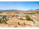 Aerial view showcases buildings on a spacious lot in a desert environment with distant mountain views at 1911 Jarvis Rd, Pahrump, NV 89060