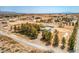 Expansive aerial view of a property featuring multiple buildings, mature trees, and desert surroundings at 1911 Jarvis Rd, Pahrump, NV 89060