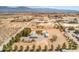 Aerial view of a property featuring multiple buildings on a large lot with surrounding desert landscape at 1911 Jarvis Rd, Pahrump, NV 89060