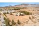 Aerial view showing multiple buildings and desert landscape with distant mountain backdrop at 1911 Jarvis Rd, Pahrump, NV 89060
