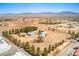 Wide aerial view of property highlighting multiple buildings, desert landscape, and mountain views in the distance at 1911 Jarvis Rd, Pahrump, NV 89060