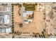 An aerial shot showcases the property layout with buildings and expansive open space, bordered by mature trees at 1911 Jarvis Rd, Pahrump, NV 89060