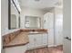 Bathroom featuring granite countertops, sink, vanity, and updated fixtures and storage cabinet at 1911 Jarvis Rd, Pahrump, NV 89060