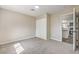 Bedroom with carpet flooring, neutral walls, closet, and interior doors leading to the kitchen at 1911 Jarvis Rd, Pahrump, NV 89060