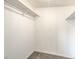Walk-in closet with white walls, upper shelving, and neutral carpeting at 1911 Jarvis Rd, Pahrump, NV 89060