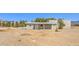 Exterior view of the home and the gravel front yard at 1911 Jarvis Rd, Pahrump, NV 89060
