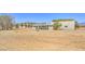 Exterior view of home featuring gravel yard, landscaping, and the overall lot at 1911 Jarvis Rd, Pahrump, NV 89060