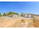 Exterior view of multiple outbuildings, sheds, and driveways around the home at 1911 Jarvis Rd, Pahrump, NV 89060