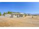 Exterior view of the home showcasing the landscaping and rural surroundings at 1911 Jarvis Rd, Pahrump, NV 89060