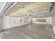 Open garage space is illuminated with overhead lighting, showcasing storage and dual entry doors at 1911 Jarvis Rd, Pahrump, NV 89060