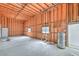 Unfinished garage space displays wood framing, windows for light, and a water heater installed at 1911 Jarvis Rd, Pahrump, NV 89060