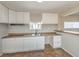 Bright kitchen offers white cabinets, granite countertops, double sink, and a pass-through to living area at 1911 Jarvis Rd, Pahrump, NV 89060