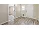 Mud room featuring gray laminate flooring, entry door, and window looking out side at 1911 Jarvis Rd, Pahrump, NV 89060