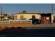 Charming single-story home with a white picket fence and a car parked in front at 203 W Pacific Ave, Henderson, NV 89015