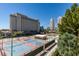 This exterior shot showcases the community, tennis courts, building and lush landscaping at 205 E Harmon Ave # 511, Las Vegas, NV 89169