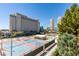 This exterior shot showcases the community, tennis courts, building and lush landscaping at 205 E Harmon Ave # 511, Las Vegas, NV 89169