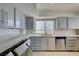 Cozy kitchen featuring grey cabinets, stainless steel appliances, and bright window at 205 E Harmon Ave # 511, Las Vegas, NV 89169