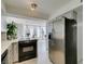 Bright kitchen area leading into a dining area with stainless steel appliances at 205 E Harmon Ave # 511, Las Vegas, NV 89169