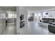 View of the home's bright open floor plan featuring tile flooring, a gray sofa, and sightlines to the kitchen and dining area at 205 E Harmon Ave # 511, Las Vegas, NV 89169