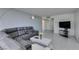 Comfortable and stylish living space with a gray sectional sofa, modern decor, and an inviting atmosphere with tile flooring at 205 E Harmon Ave # 511, Las Vegas, NV 89169