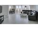 Open-concept living and dining space features large windows and tile flooring, plus a large gray sectional sofa at 205 E Harmon Ave # 511, Las Vegas, NV 89169