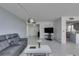 Bright living room with tile floors, gray sofa, a coffee table, and access to the kitchen at 205 E Harmon Ave # 511, Las Vegas, NV 89169