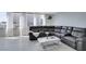 Comfortable gray sectional sofa in bright living area with floor to ceiling windows, showcasing natural light and neutral design at 205 E Harmon Ave # 511, Las Vegas, NV 89169