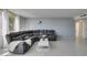 Stylish gray sectional sofa in a well-lit living space with tile flooring and an open-concept design at 205 E Harmon Ave # 511, Las Vegas, NV 89169