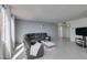 Cozy living space featuring tile flooring, a gray sectional sofa, and plenty of natural light from the bright windows at 205 E Harmon Ave # 511, Las Vegas, NV 89169