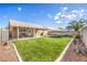 Spacious backyard with a covered patio, artificial turf, and a trampoline at 2073 Paterno Ave, Las Vegas, NV 89123