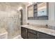 Modern bathroom featuring a glass shower, granite counters, and double sinks at 2073 Paterno Ave, Las Vegas, NV 89123