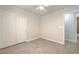 Bright bedroom featuring neutral walls, tile flooring, a ceiling fan, and a double door closet at 2073 Paterno Ave, Las Vegas, NV 89123