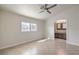 Spacious bedroom features neutral paint, a ceiling fan, tiled floor and a window at 2073 Paterno Ave, Las Vegas, NV 89123