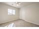 Neutral bedroom features a ceiling fan, tiled floor, window and a double door closet at 2073 Paterno Ave, Las Vegas, NV 89123