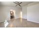 Open bedroom floor plan view of neutral paint, ceiling fan, tiled floors, with a bathroom entrance at 2073 Paterno Ave, Las Vegas, NV 89123