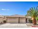 Charming single-story home with a three-car garage and a beautiful palm tree in the front yard at 2073 Paterno Ave, Las Vegas, NV 89123