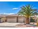 Attractive single-story home with a three-car garage, desert landscaping, and a large palm tree at 2073 Paterno Ave, Las Vegas, NV 89123