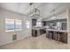 Bright kitchen includes stainless appliances, tile backsplash, granite counters and an island with seating at 2073 Paterno Ave, Las Vegas, NV 89123
