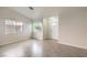 Comfortable living room with tile floors, large windows, and a welcoming front door at 2073 Paterno Ave, Las Vegas, NV 89123