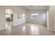 Bright and airy living room featuring tile floors and an arched doorway to the kitchen at 2073 Paterno Ave, Las Vegas, NV 89123