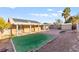 Large backyard with a covered patio, storage sheds, and artificial turf is perfect for entertaining or relaxing outdoors at 2315 Opponents Ridge St, North Las Vegas, NV 89032