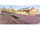 Expansive backyard featuring a covered patio, brick pavers, and mature trees offers ample space for outdoor activities at 2315 Opponents Ridge St, North Las Vegas, NV 89032