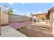 An outside view of a covered patio, storage shed, brick pavers, and artificial turf, offering a serene outdoor experience at 2315 Opponents Ridge St, North Las Vegas, NV 89032